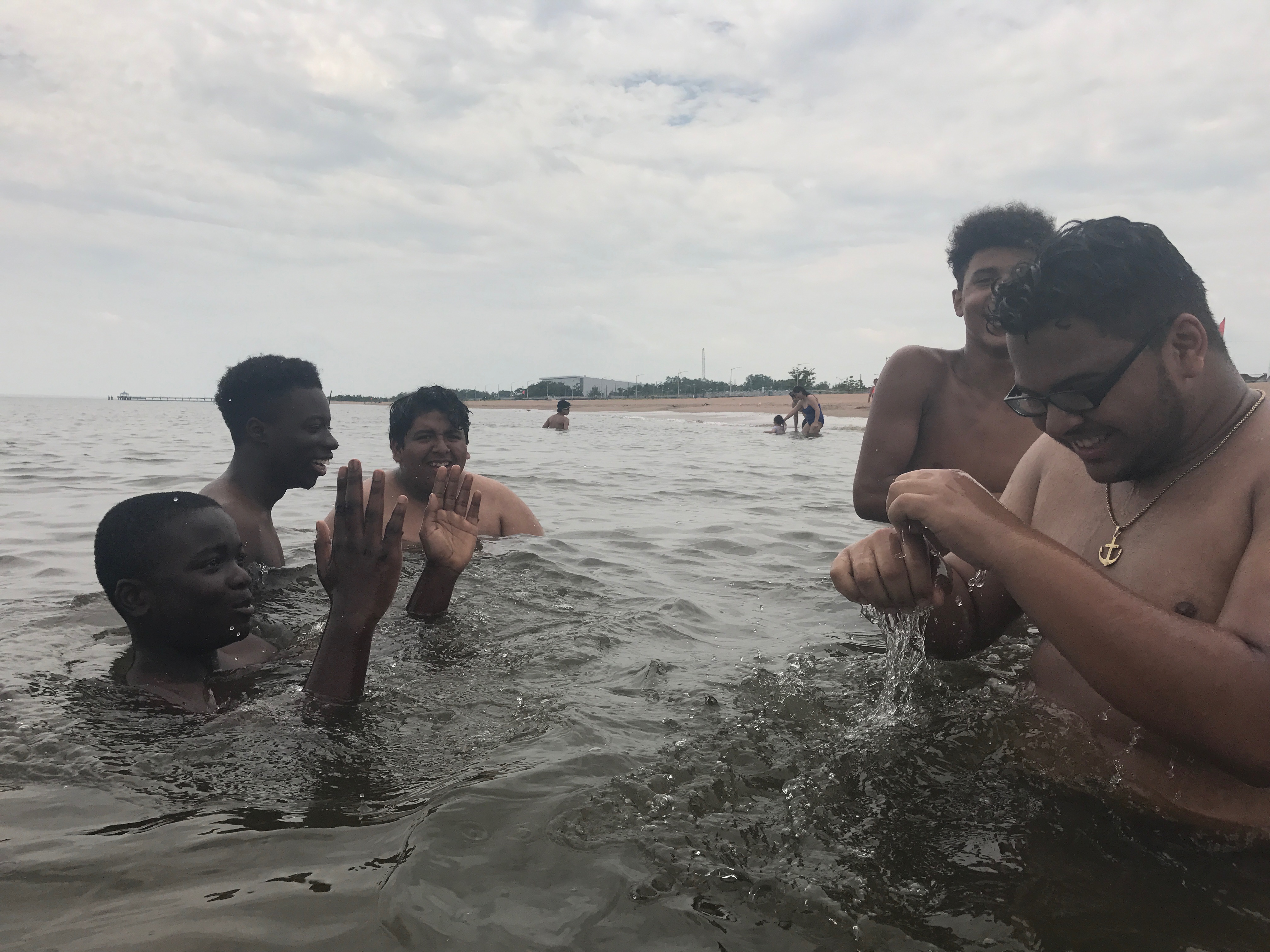 NYC ICO participants splash around and swim at the beach. 