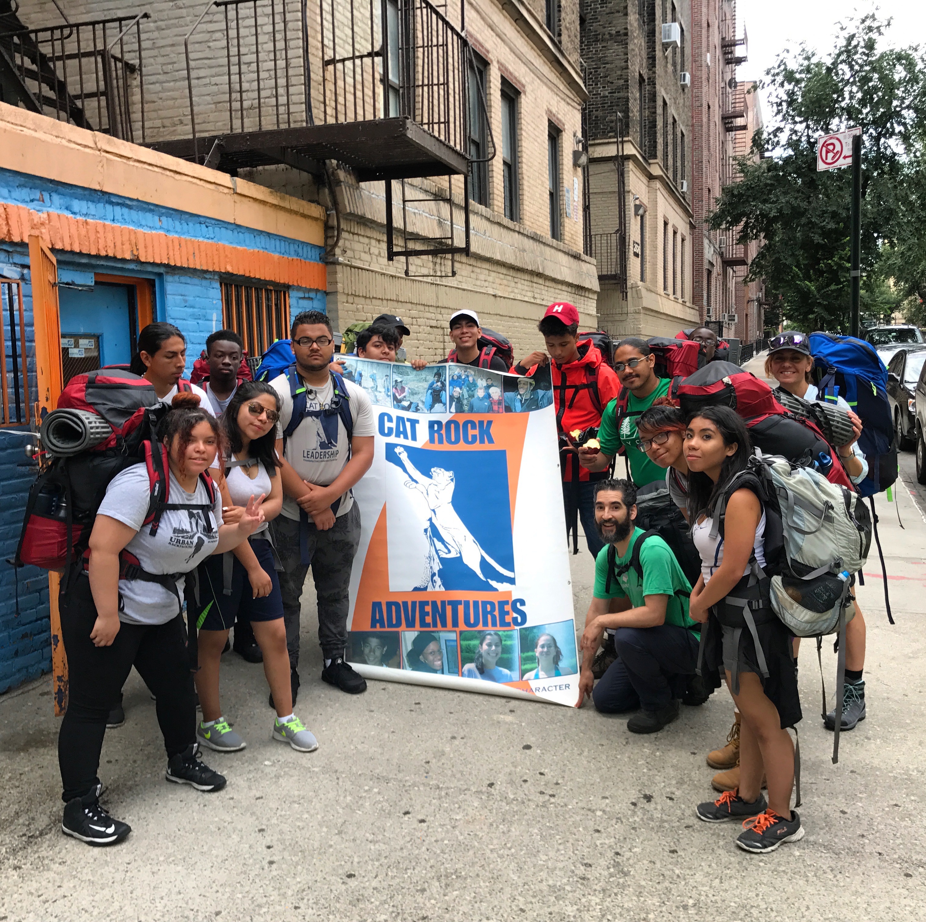 NYC ICO participants pose for a group photo with their banner. 