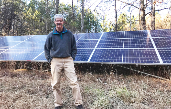 Mark Johnston with solar array on his property