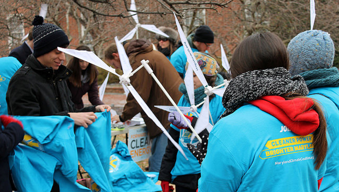 Passing out shirts, signs & windmills