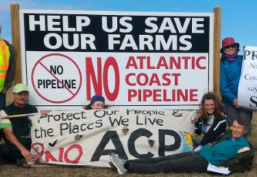 Large anti-pipeline signs about saving farms and the places we love