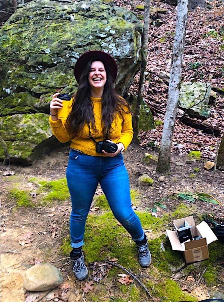 Laura in the field, smiling and happy doing conservation work