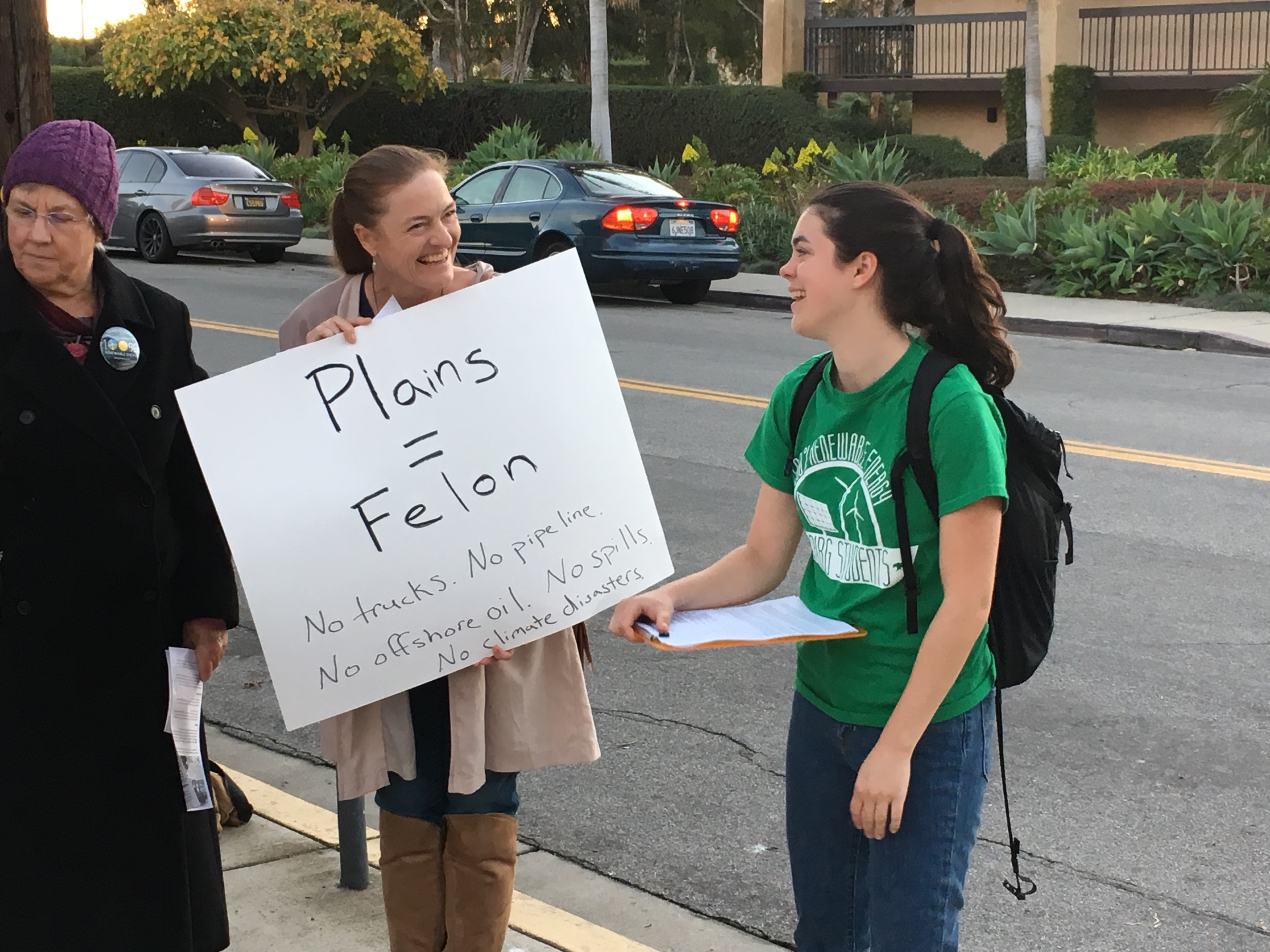 Sierra Club Los Padres Chapter Chair Katie Davis carries a reminder of Plains Pipeline's criminal past at its new pipeline open-house Jan 31, 2019