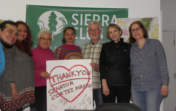 People posing with a heart sign