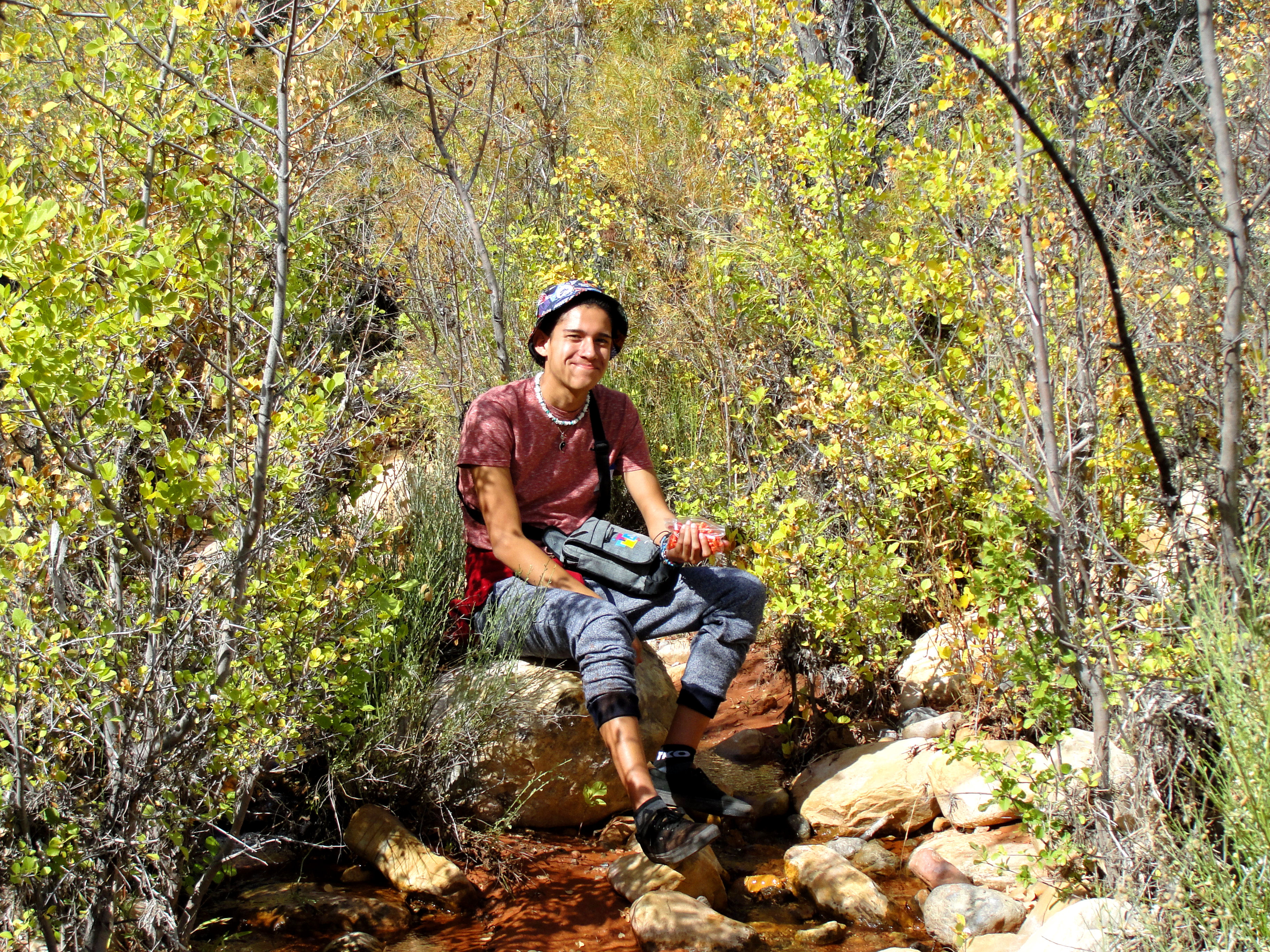 DSC07790b Young Lady Stands at the edge of the small water fall at oak creek in Red Rock
