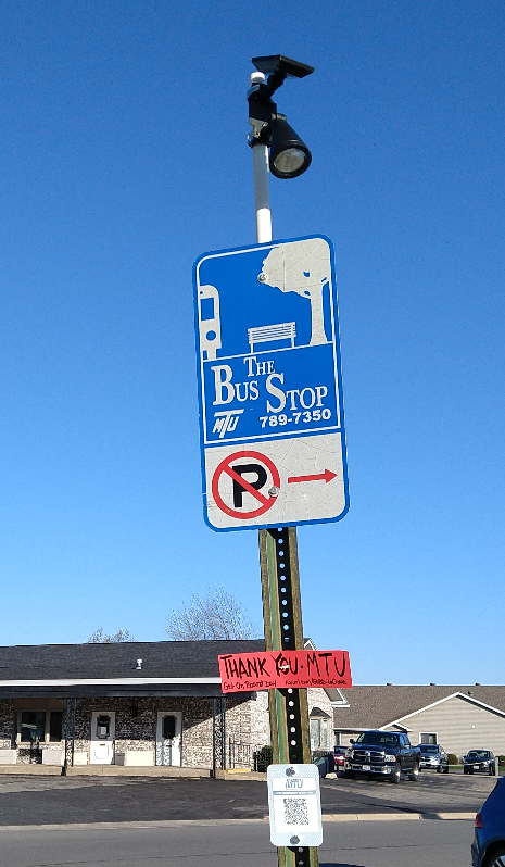 A sign taped to bus stop says "Thank You MTU"