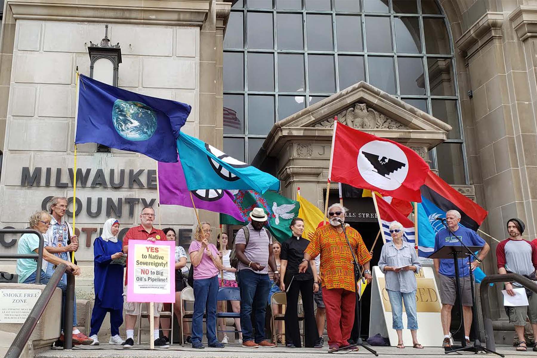 Climate protestors gather on the steps of the Milwaukee County Courthouse