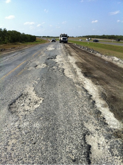 Torn up shoulder on road in the Eagleford Shale region