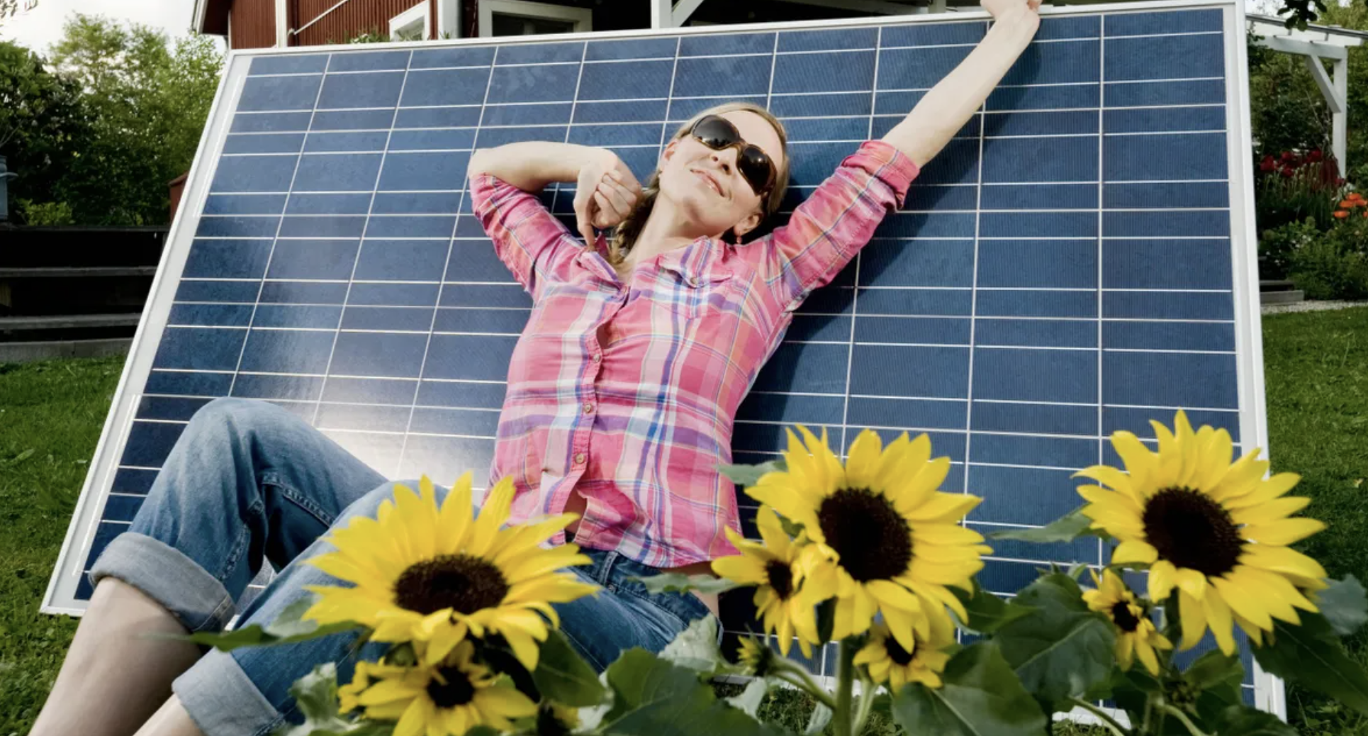 sunbather Image of a woman sunbathing on a solar panel with sunflowers