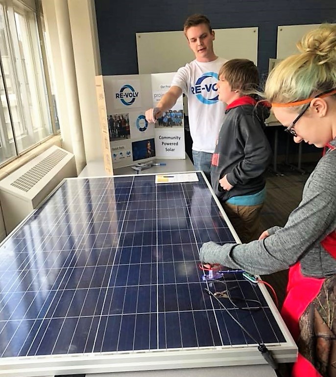 Solar Ambassadors explaining solar panels 