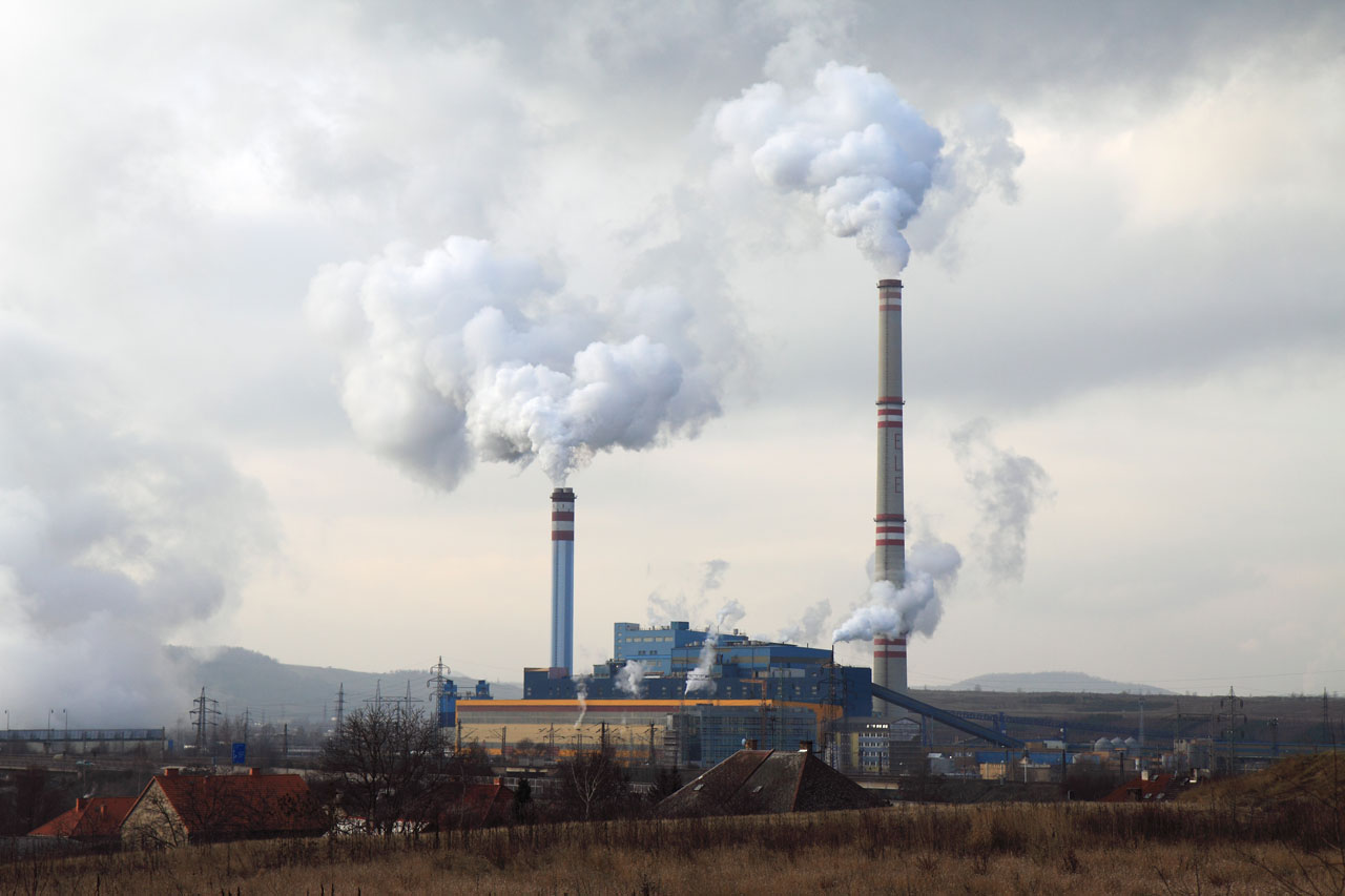 Coal plant releasing plumes of smoke into the sky