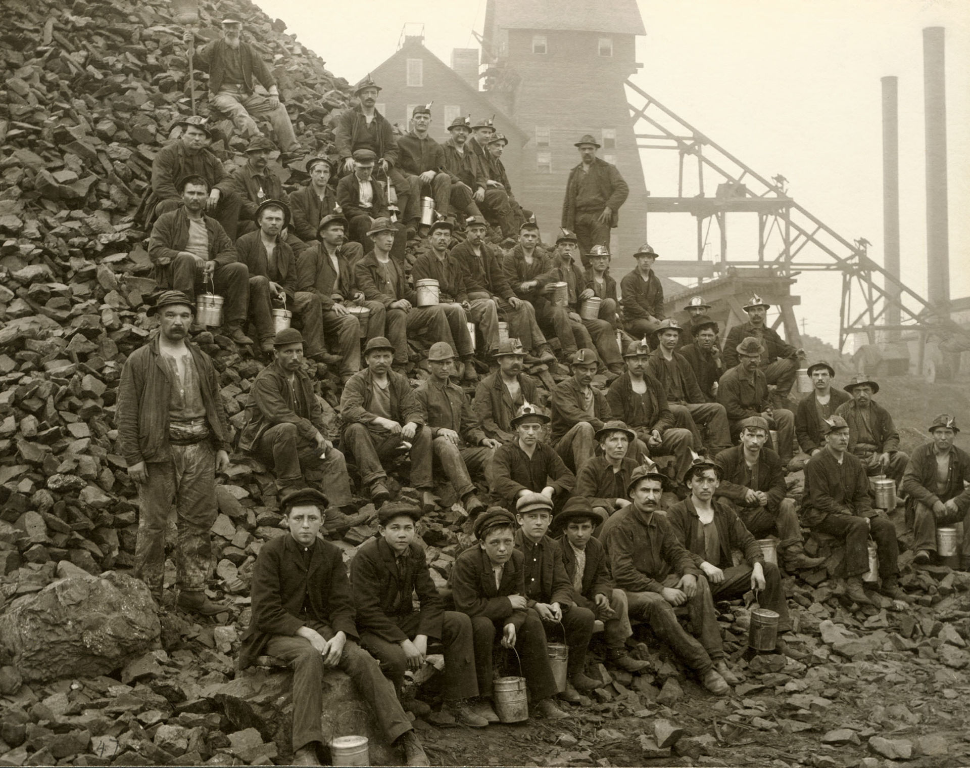 Miners posing next to rocks in 1905