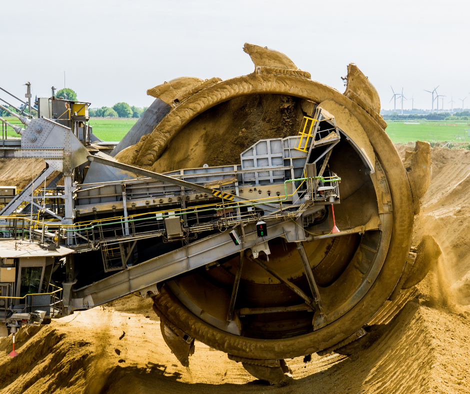 Heavy machinery excavating sand for mining