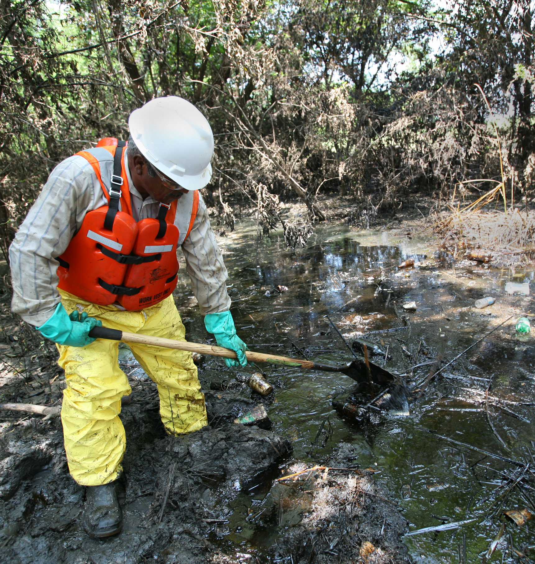 FEMA worker cleans up an oil spill