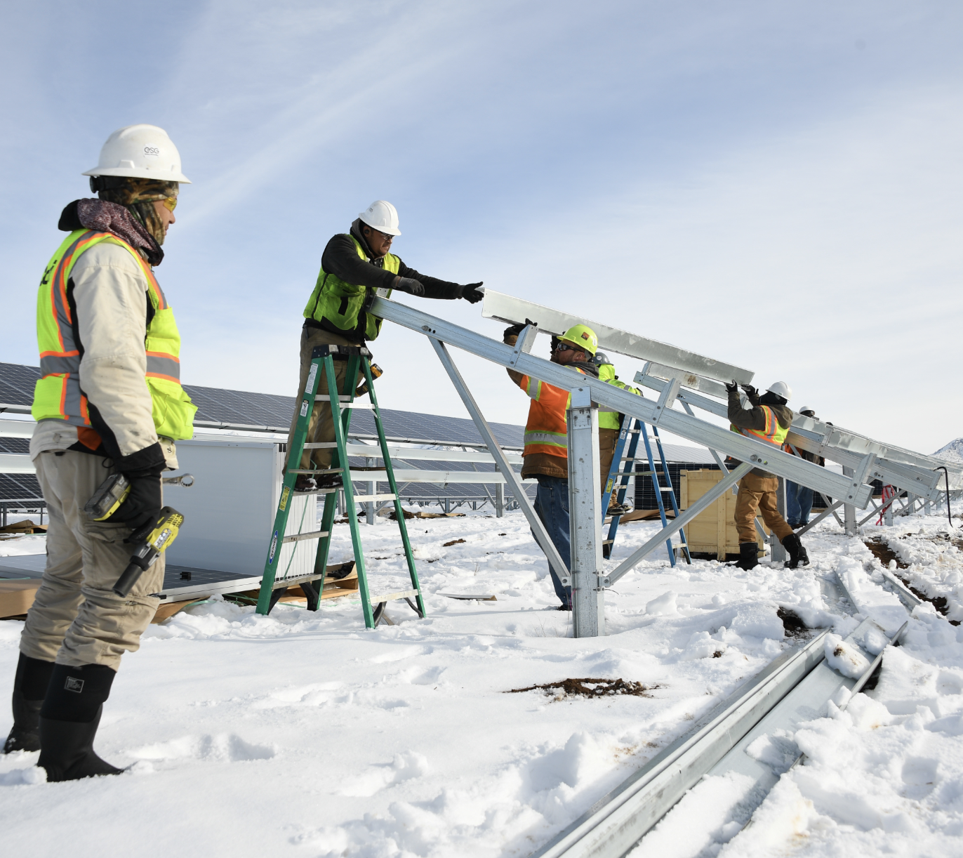 Workers assembling solar panels in the snow