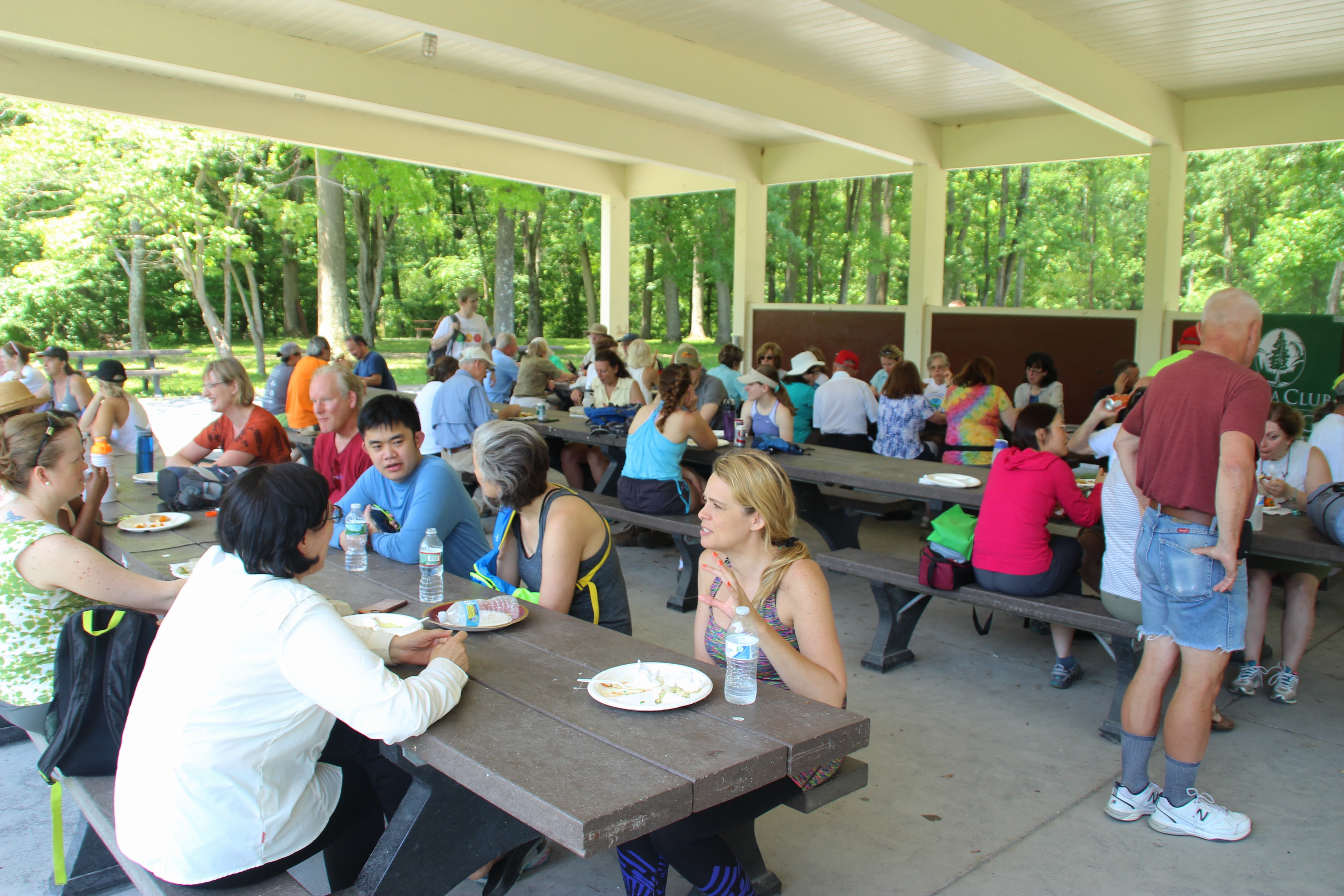 Group sits at picnic table to eat lunch