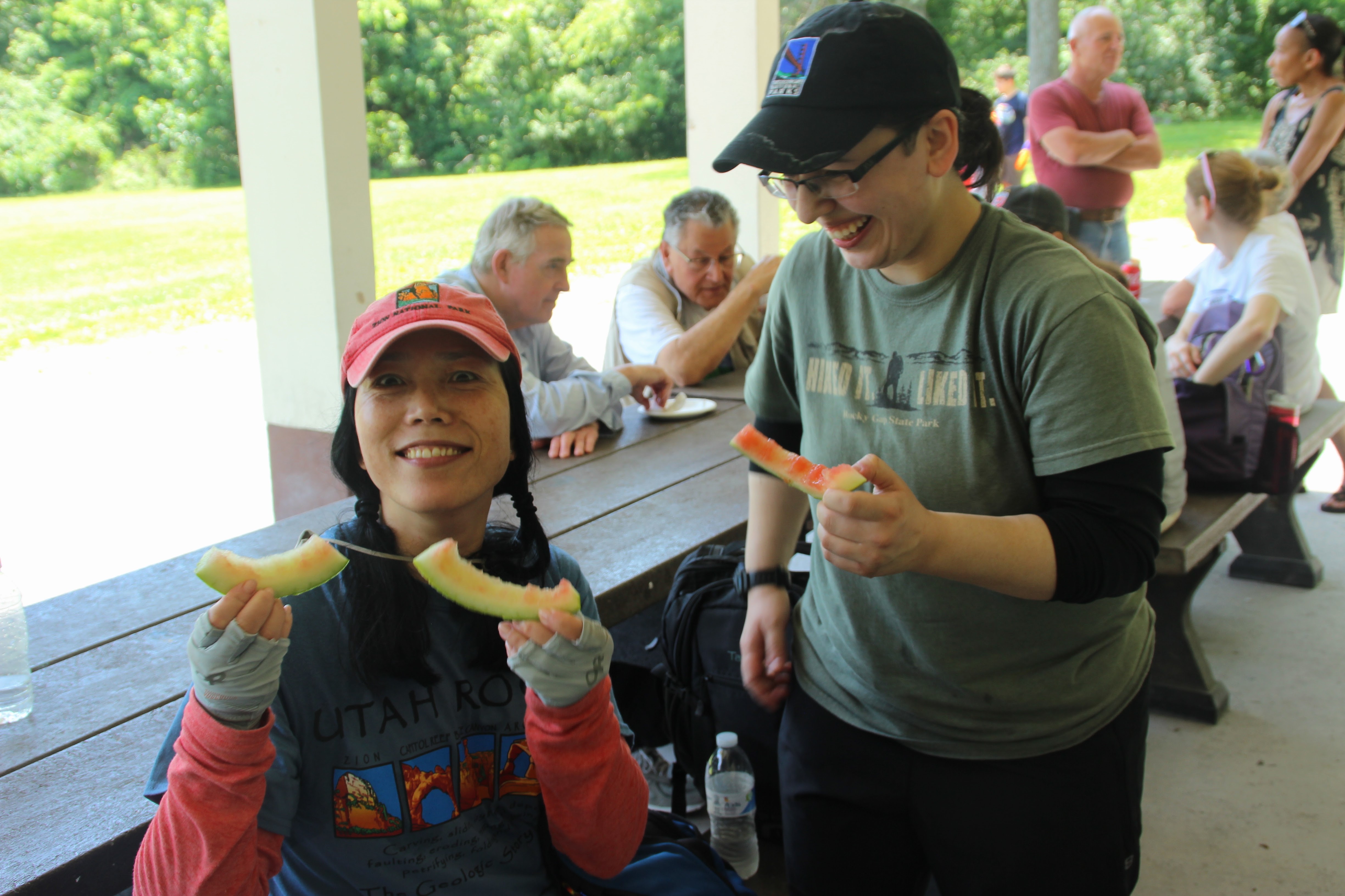 Two women smile with watermelon at the ODH Picnic