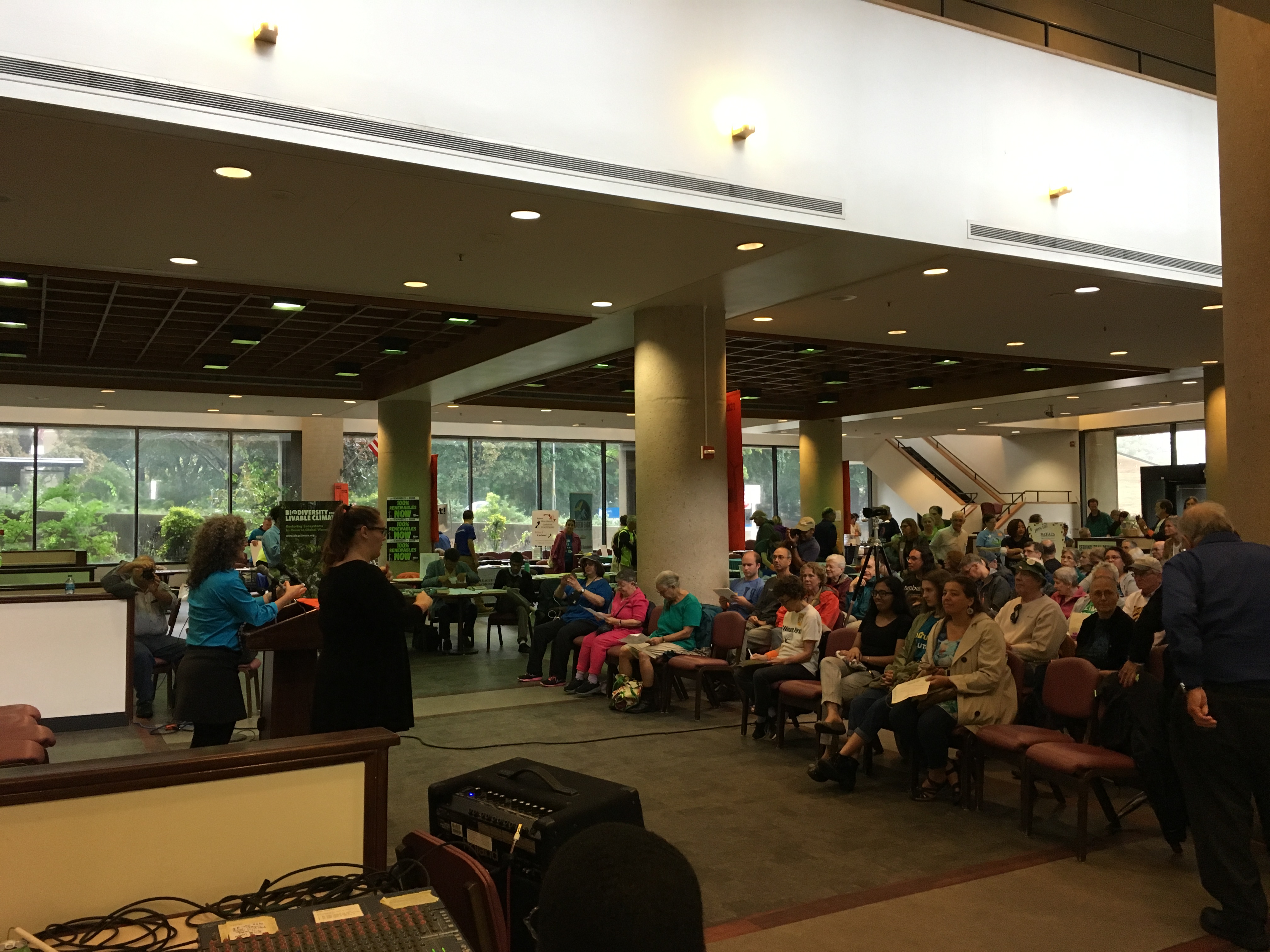 photo of crowd indoors facing a podium