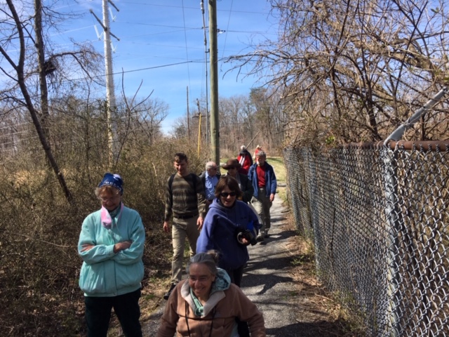 Volunteers walk by a fence at Buck Lodge Community Park