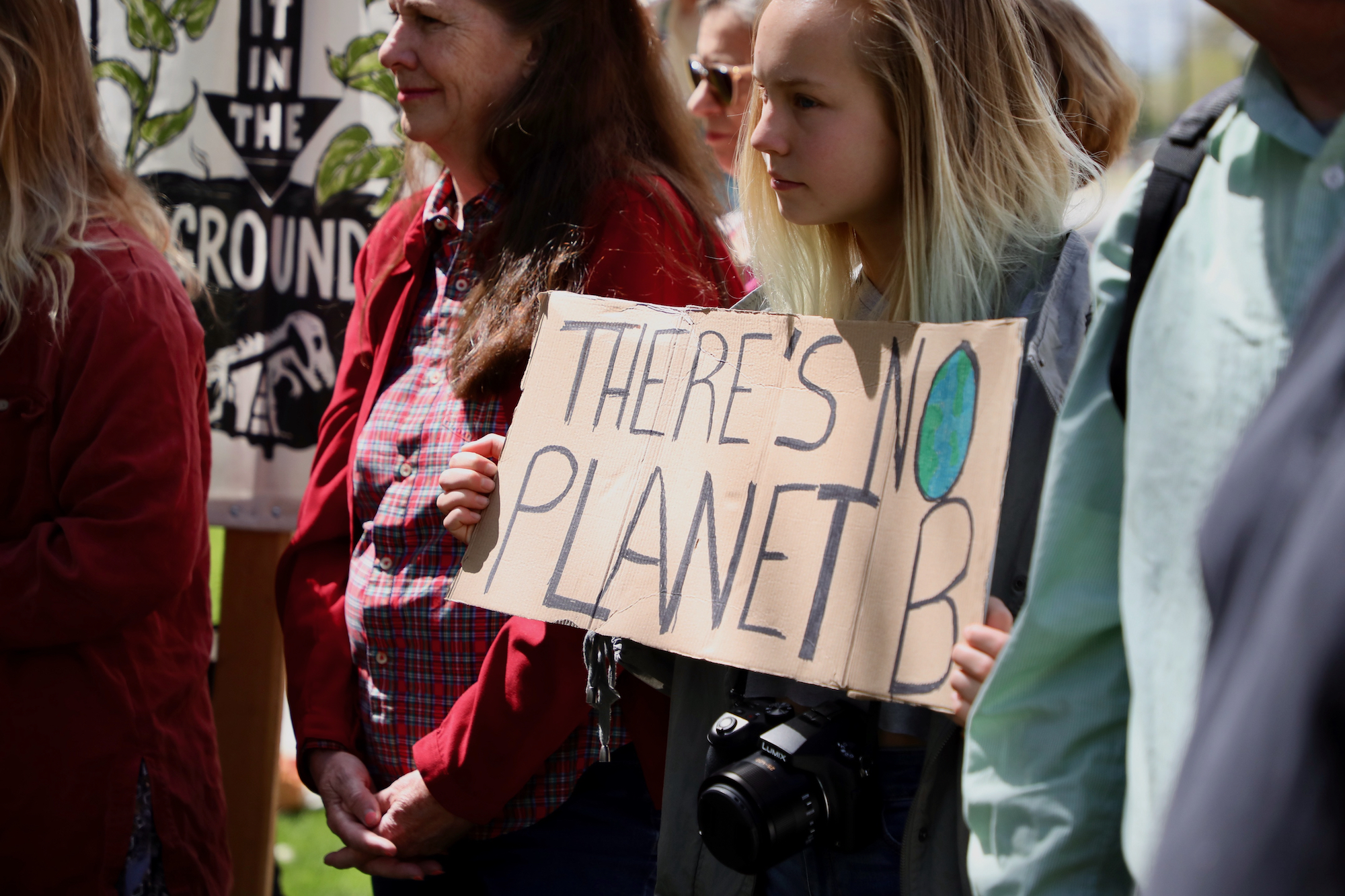 Youth activist holds up sign that says "There's No Planet B"