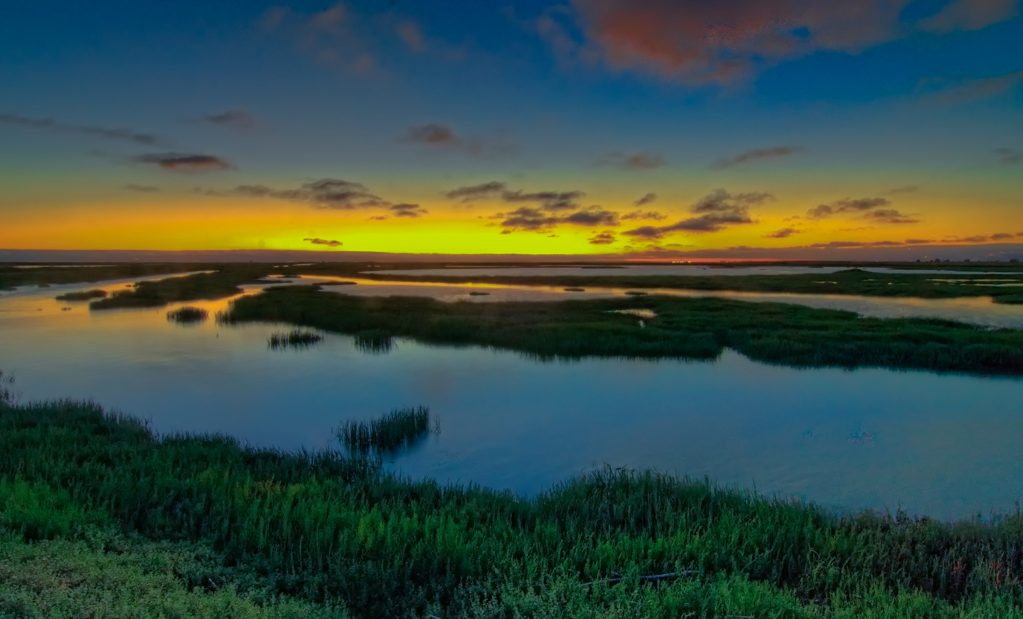 A sunset over the Bay marshes on the Hayward Shoreline.