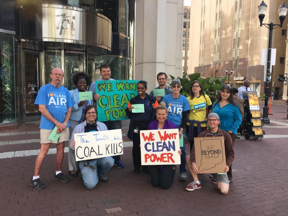 Participants with signs campaigning for clean energy