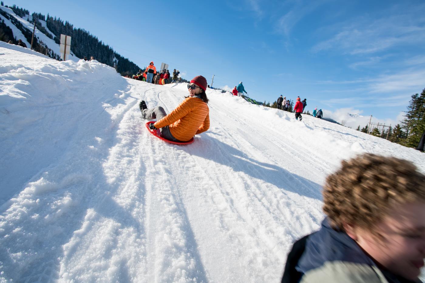 ICO Seattle leader and student sledding at Snoqualmie Pass