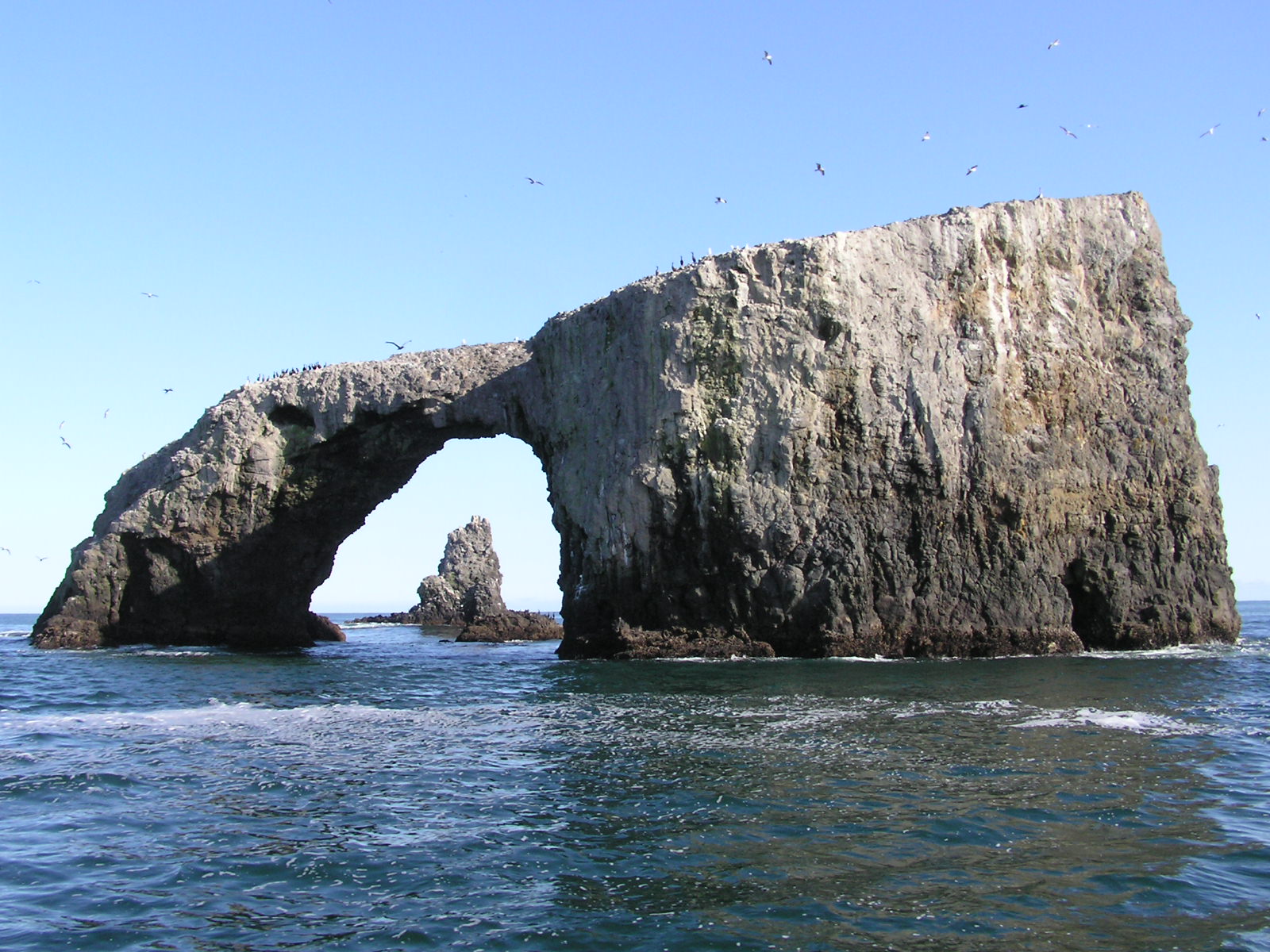 A sea arch against blue sky