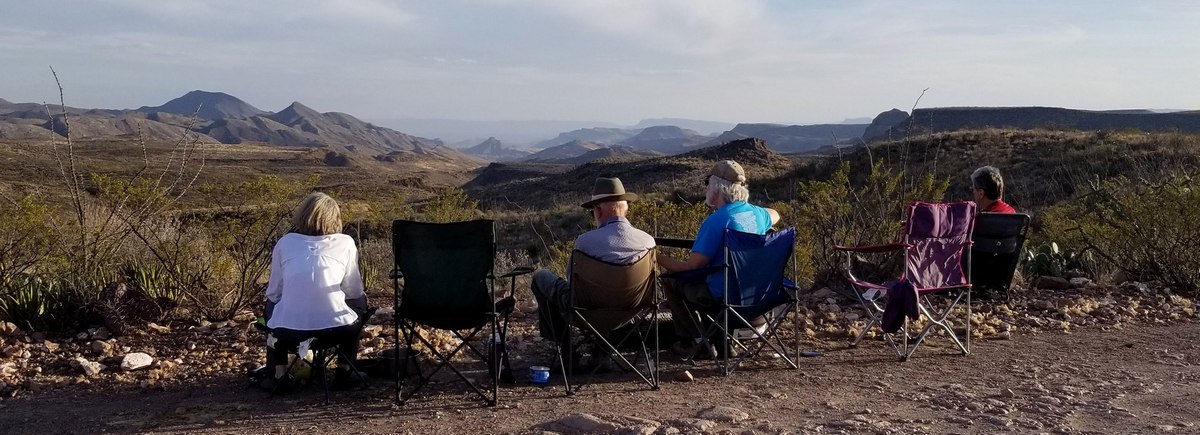 Hiking buddies ensconced at a nice view of west side of the Solitario for music and happy hour