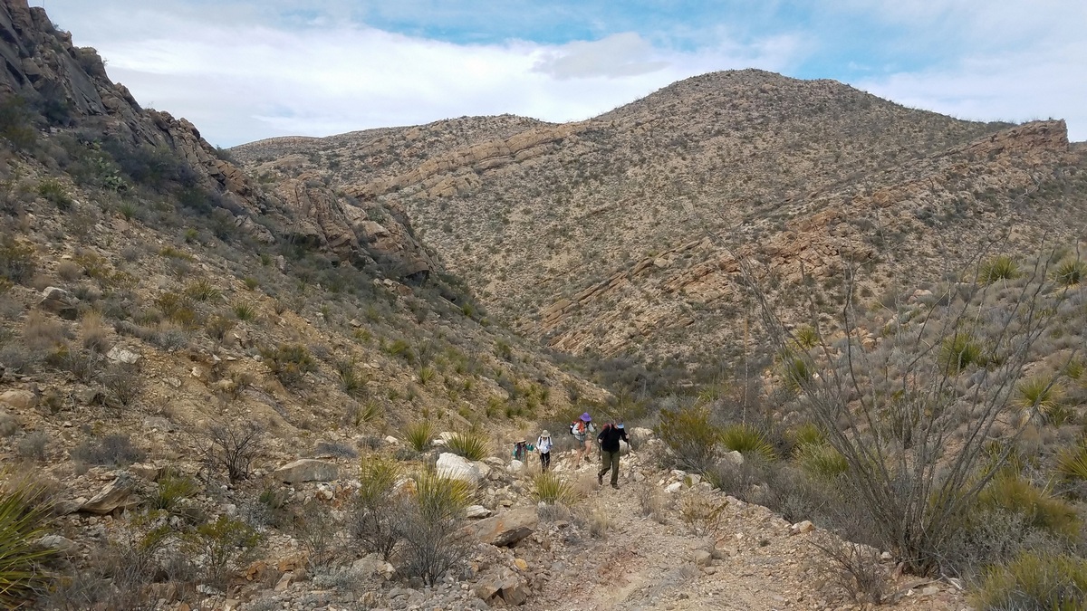 Hiking buddies coming around the southwest corner of the Solitario west side loop.