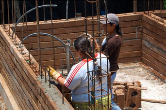 Family building their own compressed earth block homes