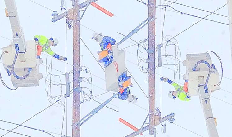 crews working on utility poles