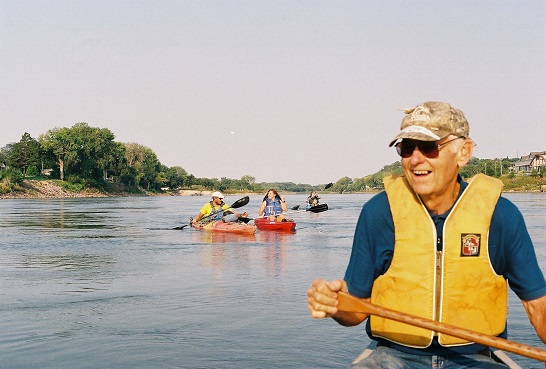 photoGraham Jordison, on the left, paddles in the morning light on the Missouri River near Sioux City along with Sierra Club members. (Photo by Emma Colman)