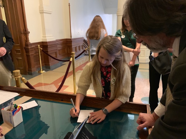 Filling out form in House lobby