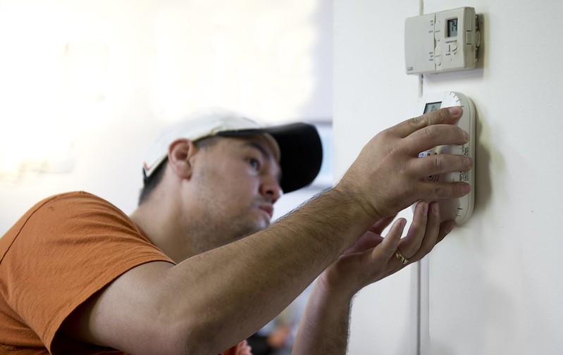 Person programming thermostat