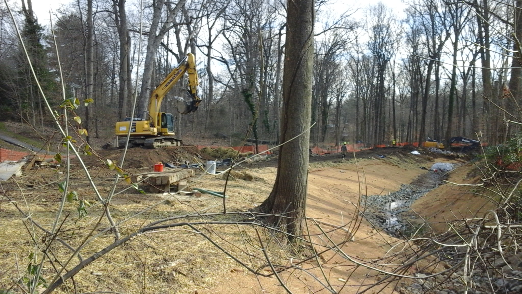 Heavy machinery and trees removed, rocks in stream