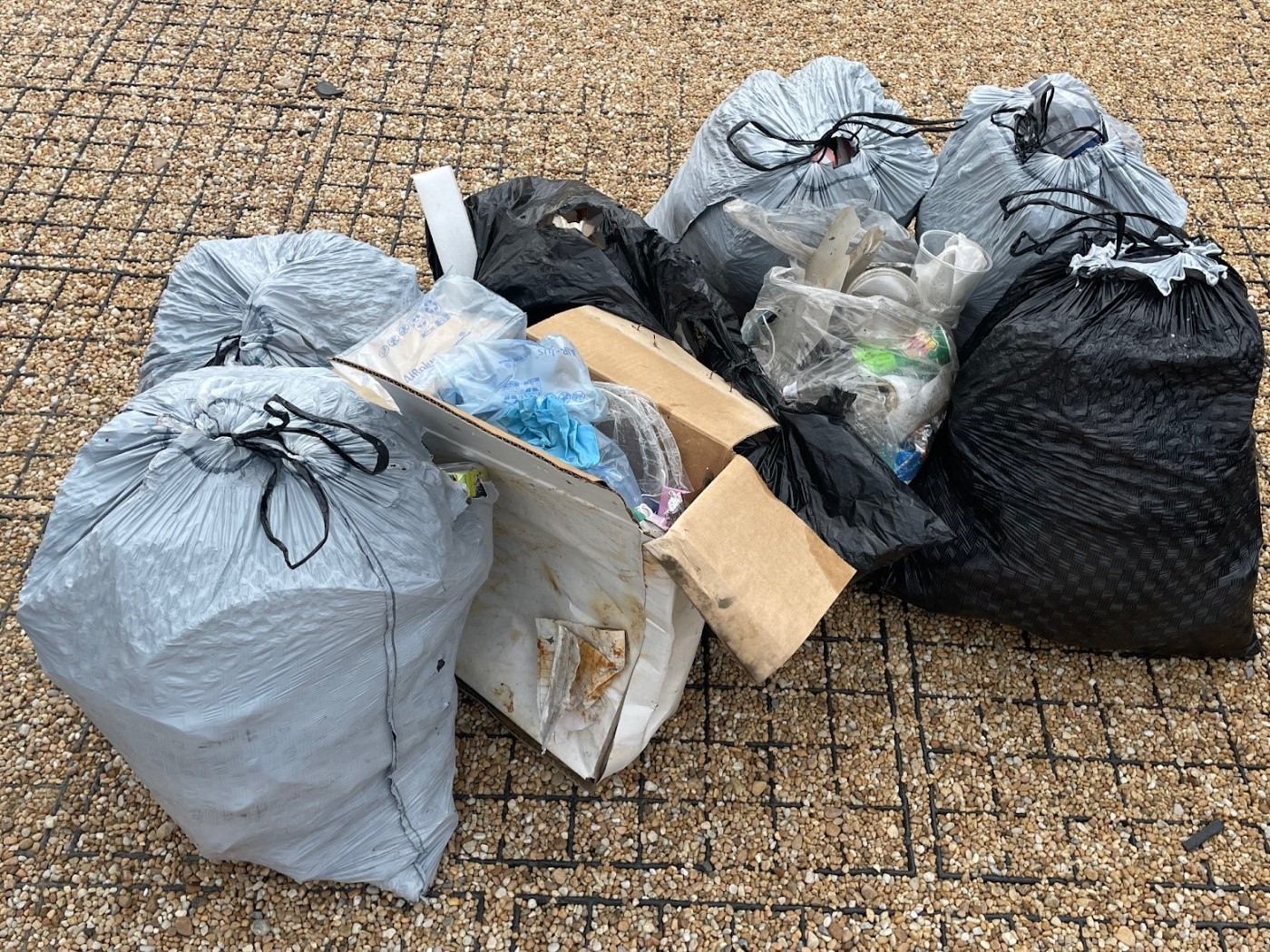 about eight trash bags filled with litter