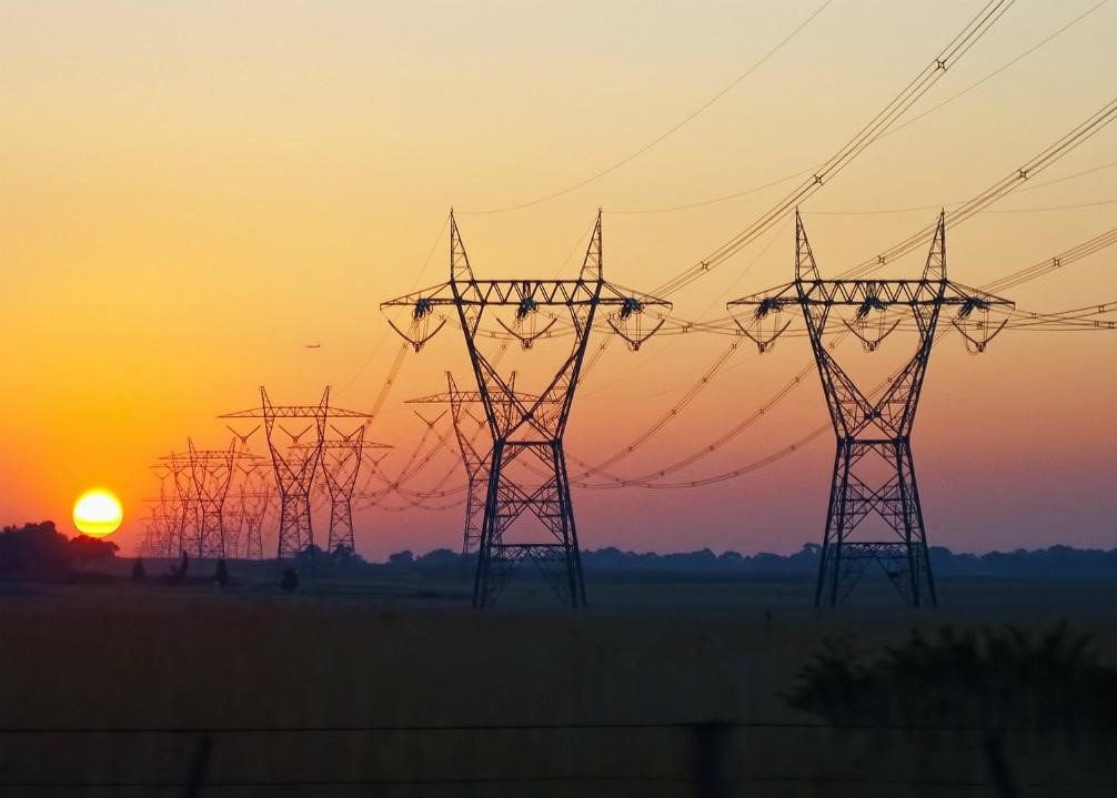 power lines at dusk with sun setting