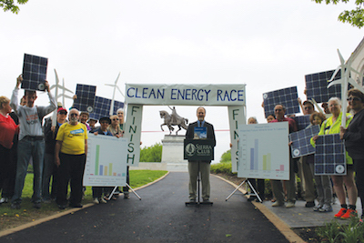 Andy Knott explains the new report to clean energy supporters on Art Hill in St. Louis.