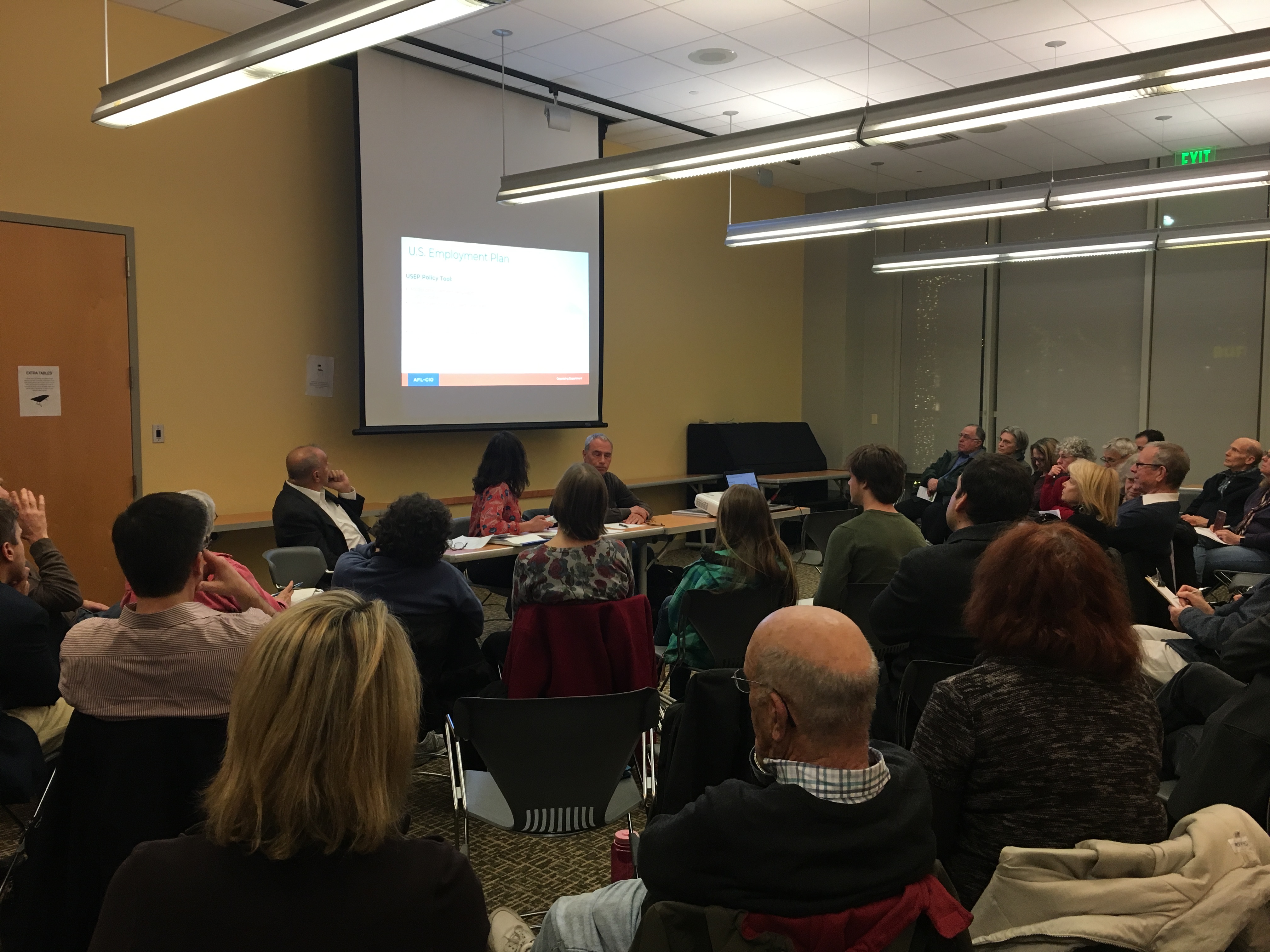 Group attending panel discussion on labor and the environment. Photo 1 of 5