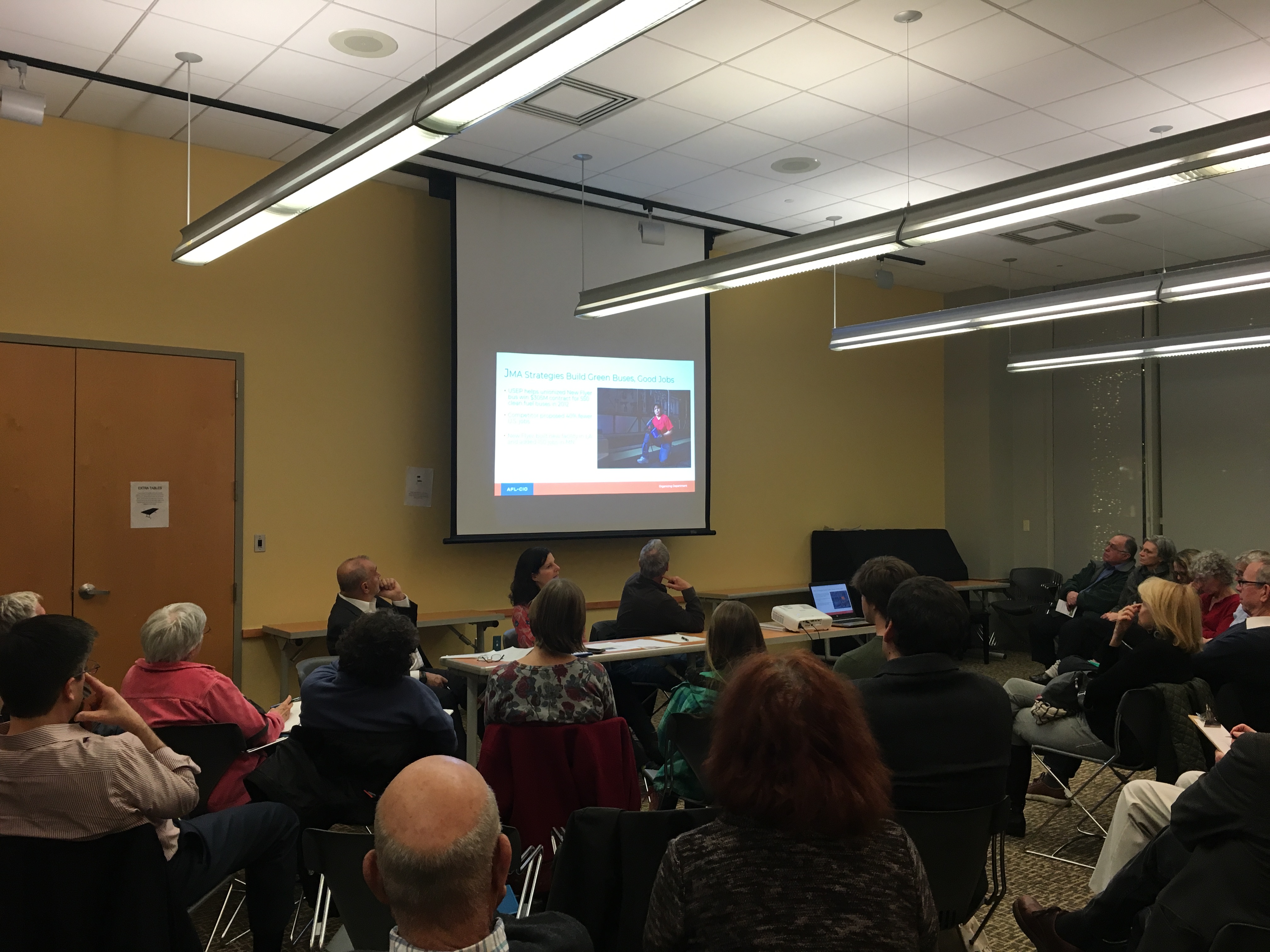 Group attending panel discussion on labor and the environment. Photo 2 of 5