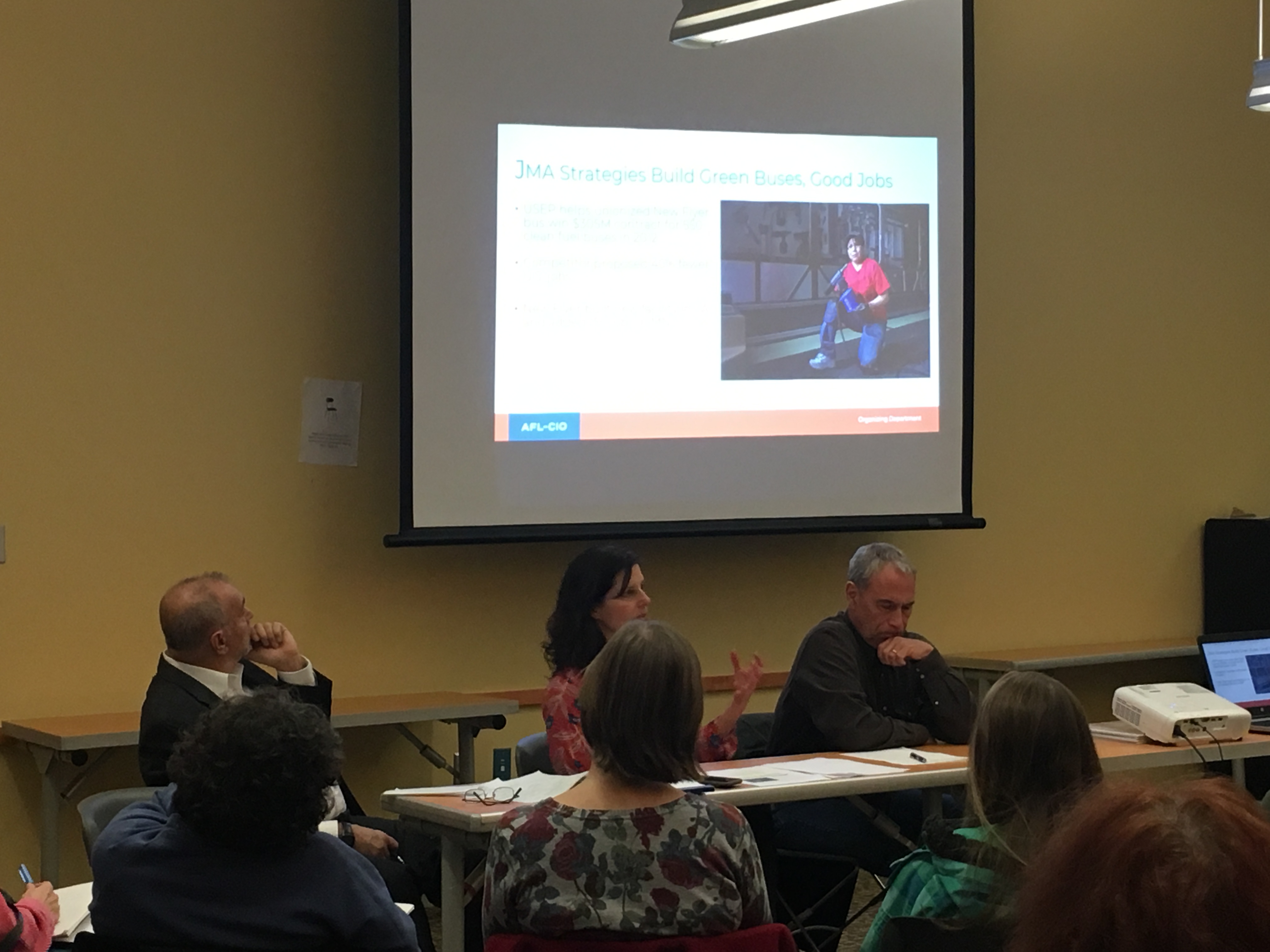 Group attending panel discussion on labor and the environment. Photo 3 of 5