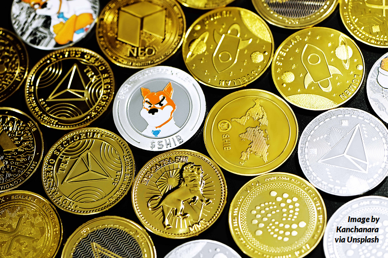 A stock image of many different coins representing cryptocurrency brands