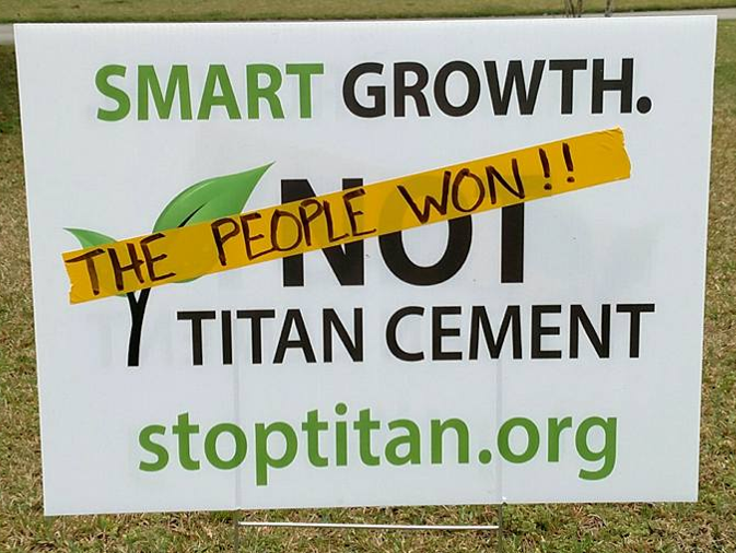 A Stop Titan sign covered with tape reading "The People Won"