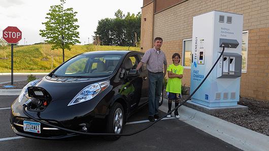 photo of people charging up an EV