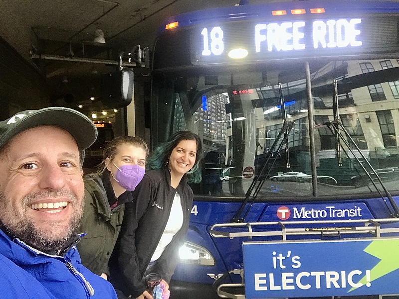 Photo of smiling people about to board a Metro Transit electric bus