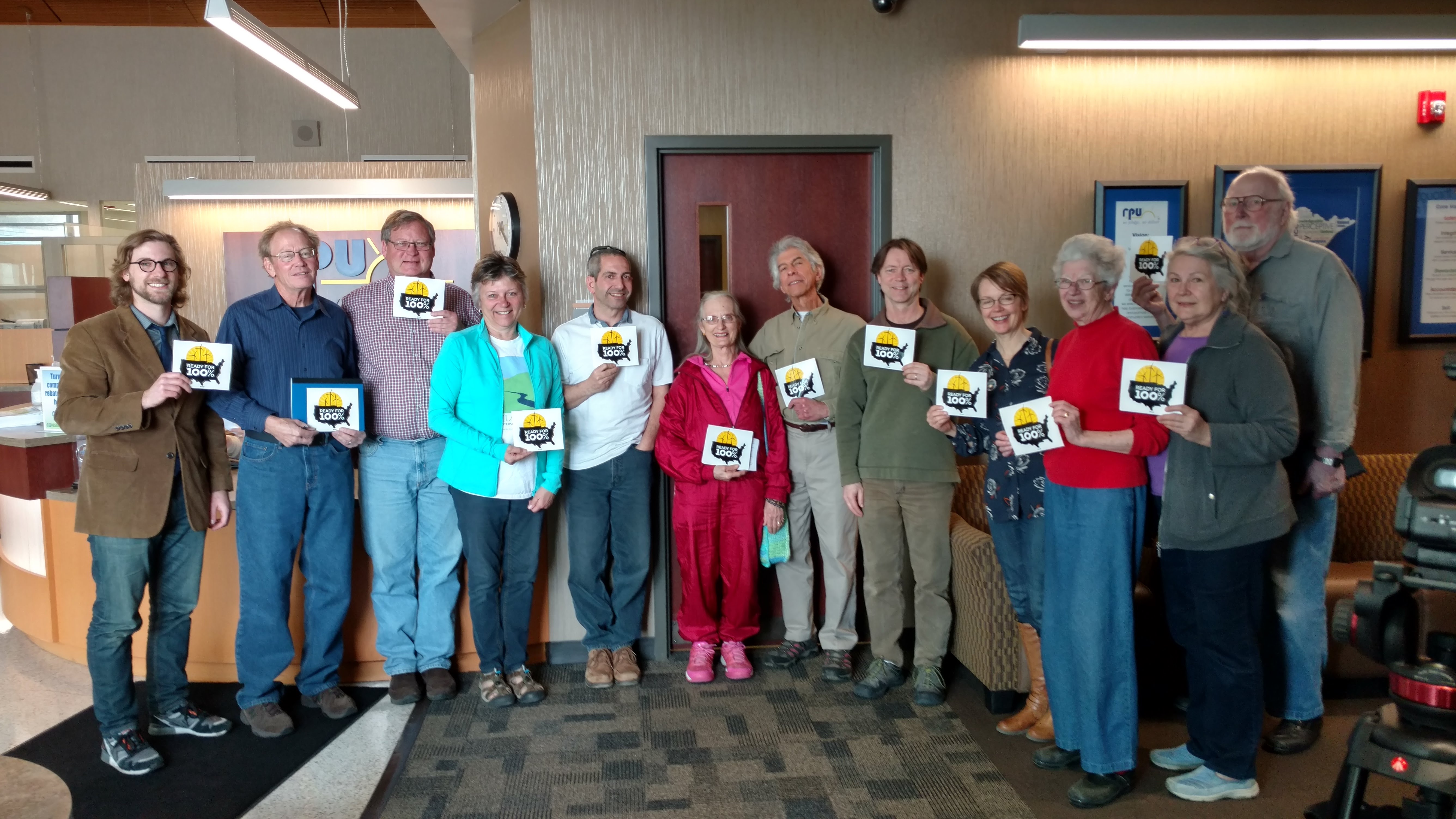 Sierra Club activists outside of Rochester Public Utilities board room following the historic commitment to plan for 100% renewable energy.