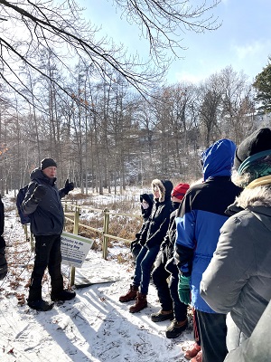 The author, Don Luce, giving a talk at the Theodore Wirth bog on a winter outing. Photo credit: Jean Hopfensperger