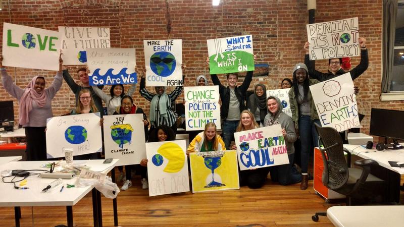 Photo credit: staff. High school student-organizers held a sign making party to support Rochester climate marches and rallies.