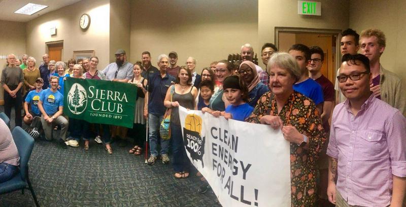 Photo credit: staff. Rochester community members rally for 100% clean energy at City Hall